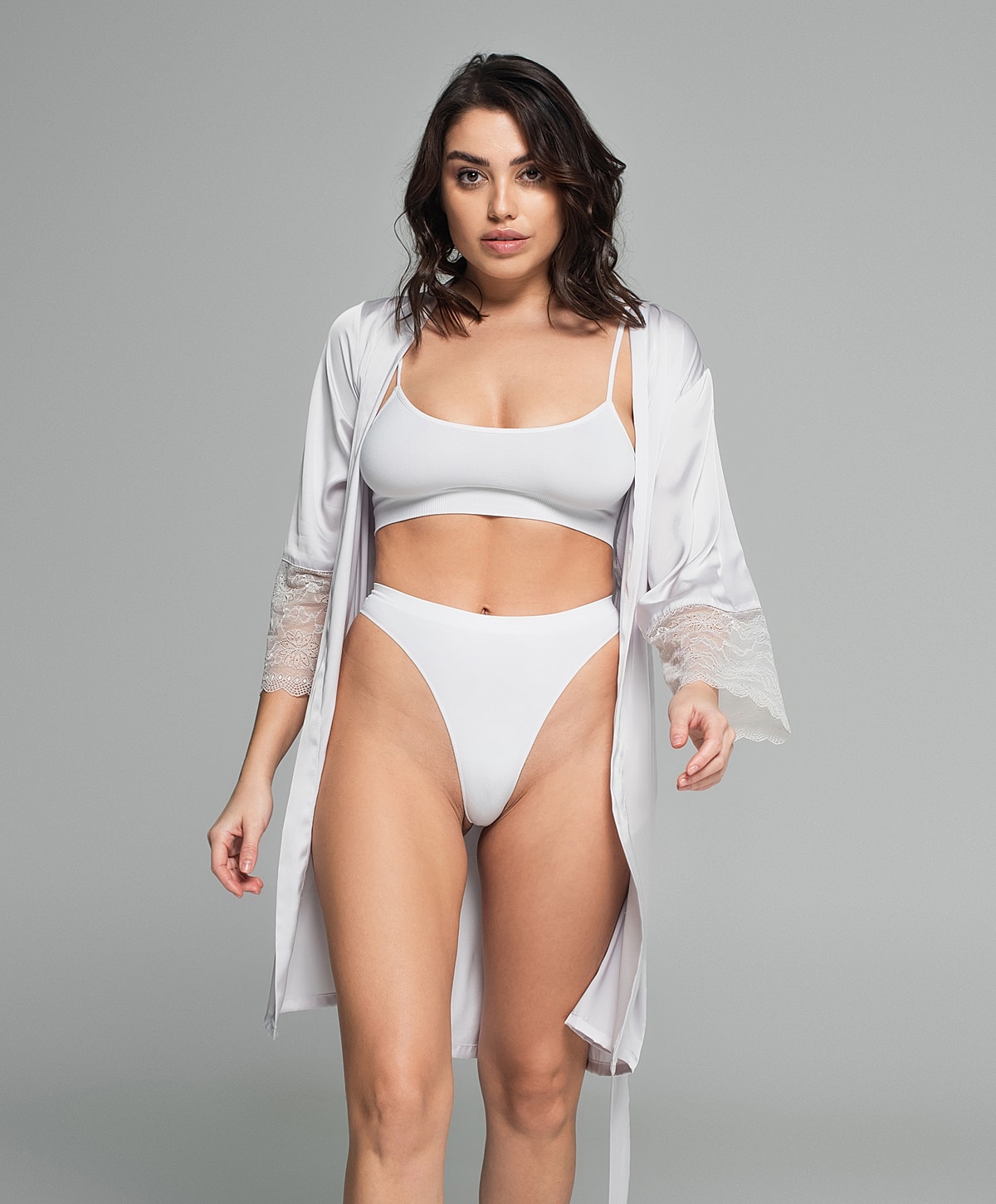 Model wearing white lingerie and satin robe.