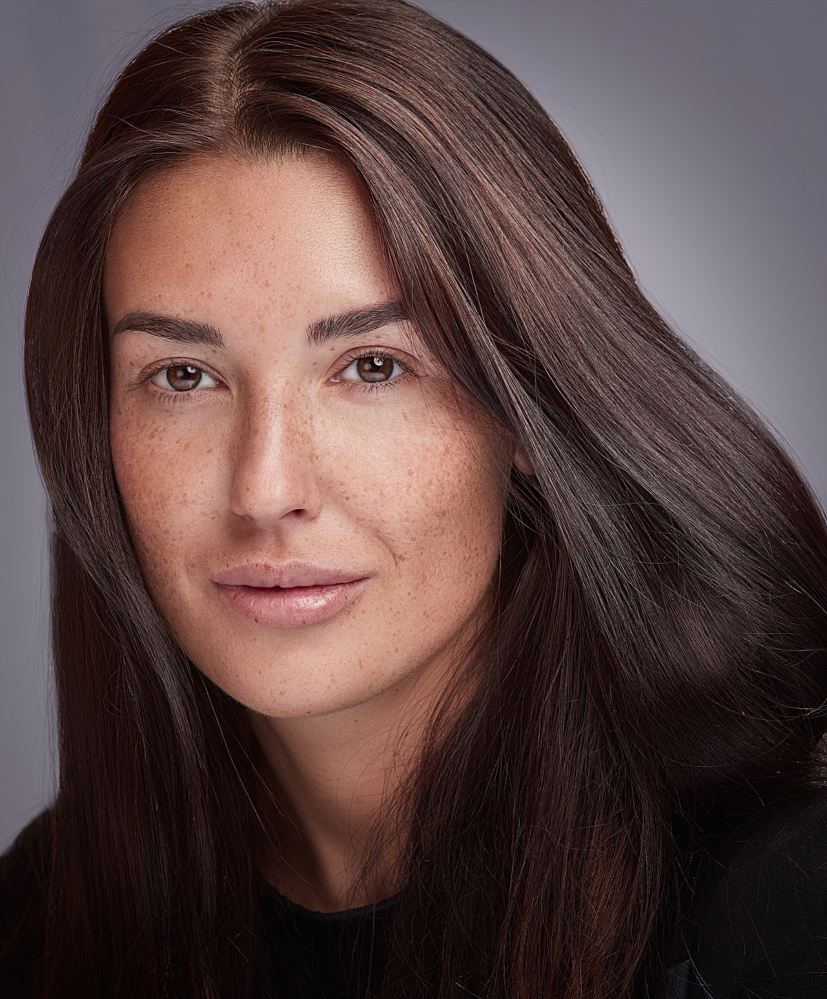 Portrait of a woman with long, dark hair.