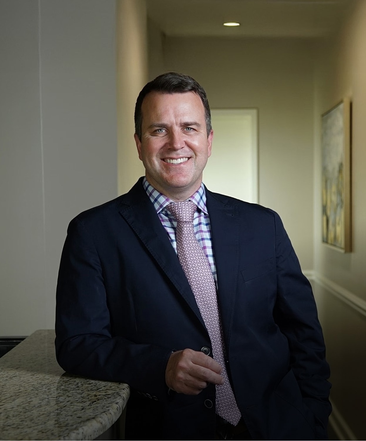 Smiling professional man in formal attire.
