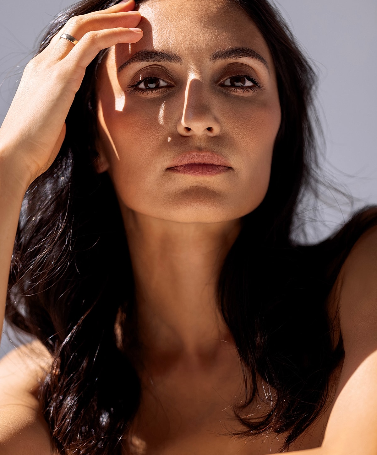 Woman with long hair in a white top.