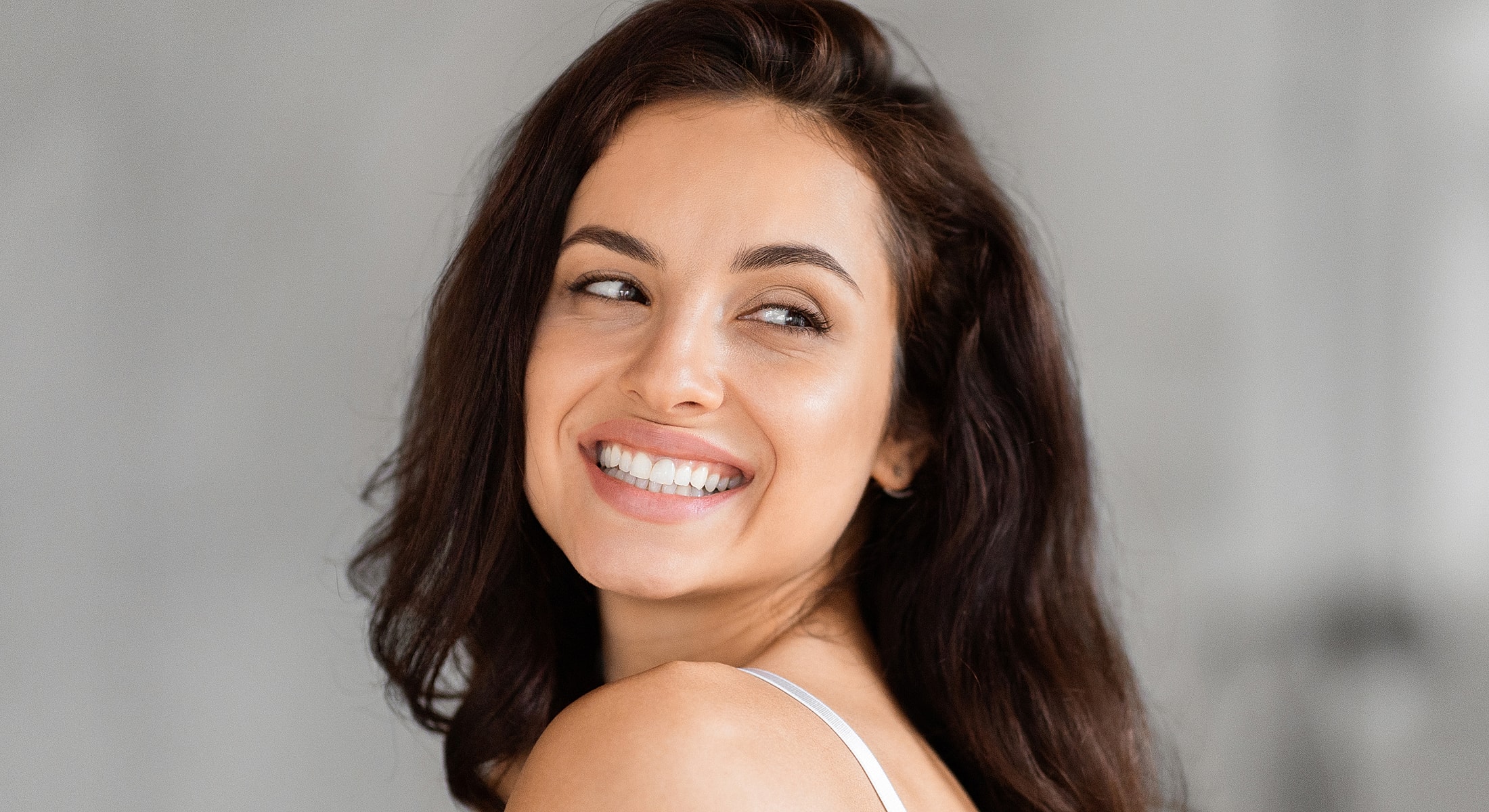 Smiling woman with dark hair and gentle expression.